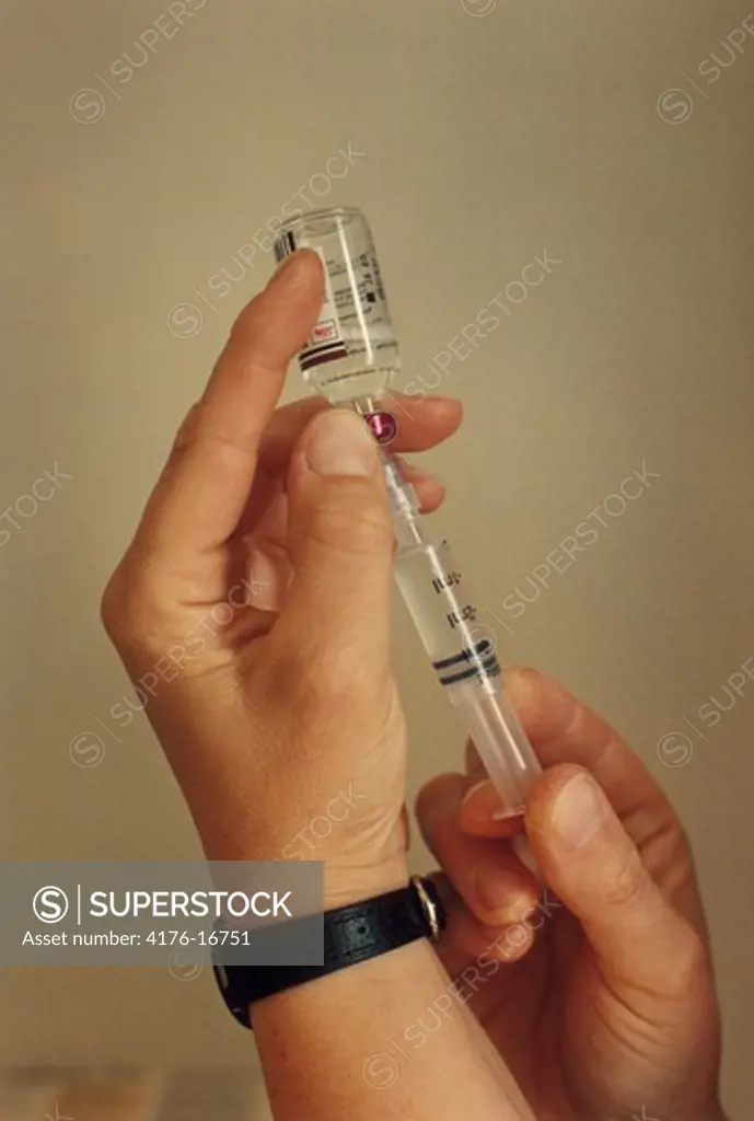 A syringe and a glass in a close up shot