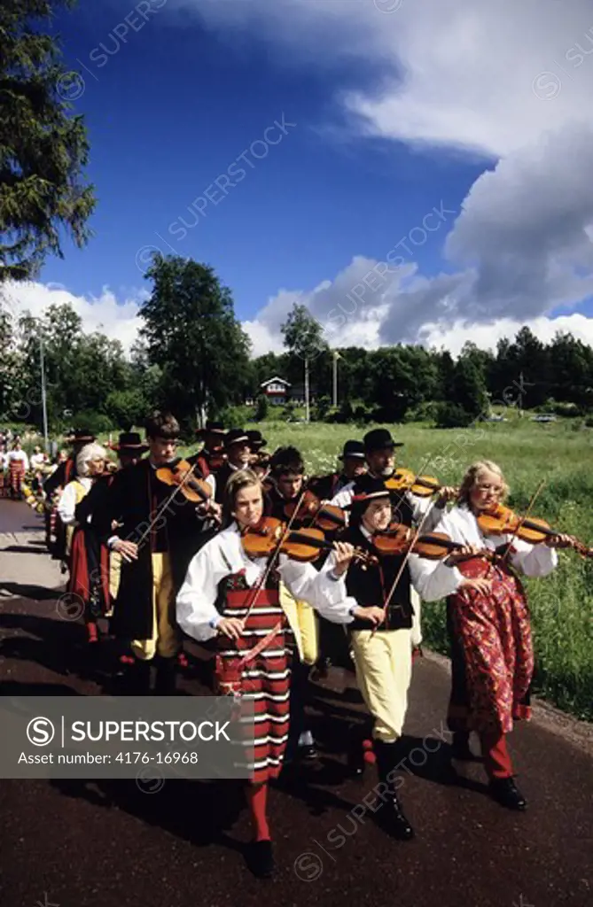 Musicians marching in folk costumes, Dalarna, Sweden