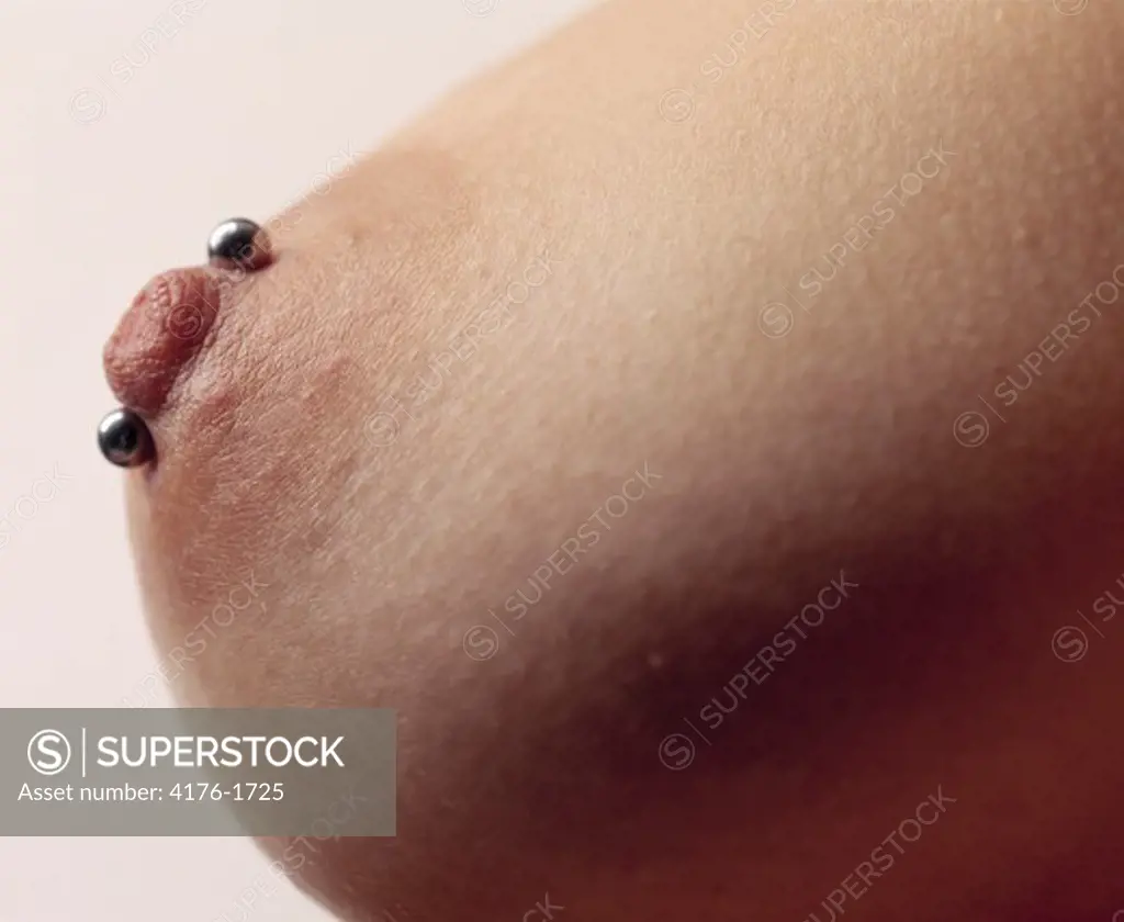 Close-up of pierced nipple of a woman