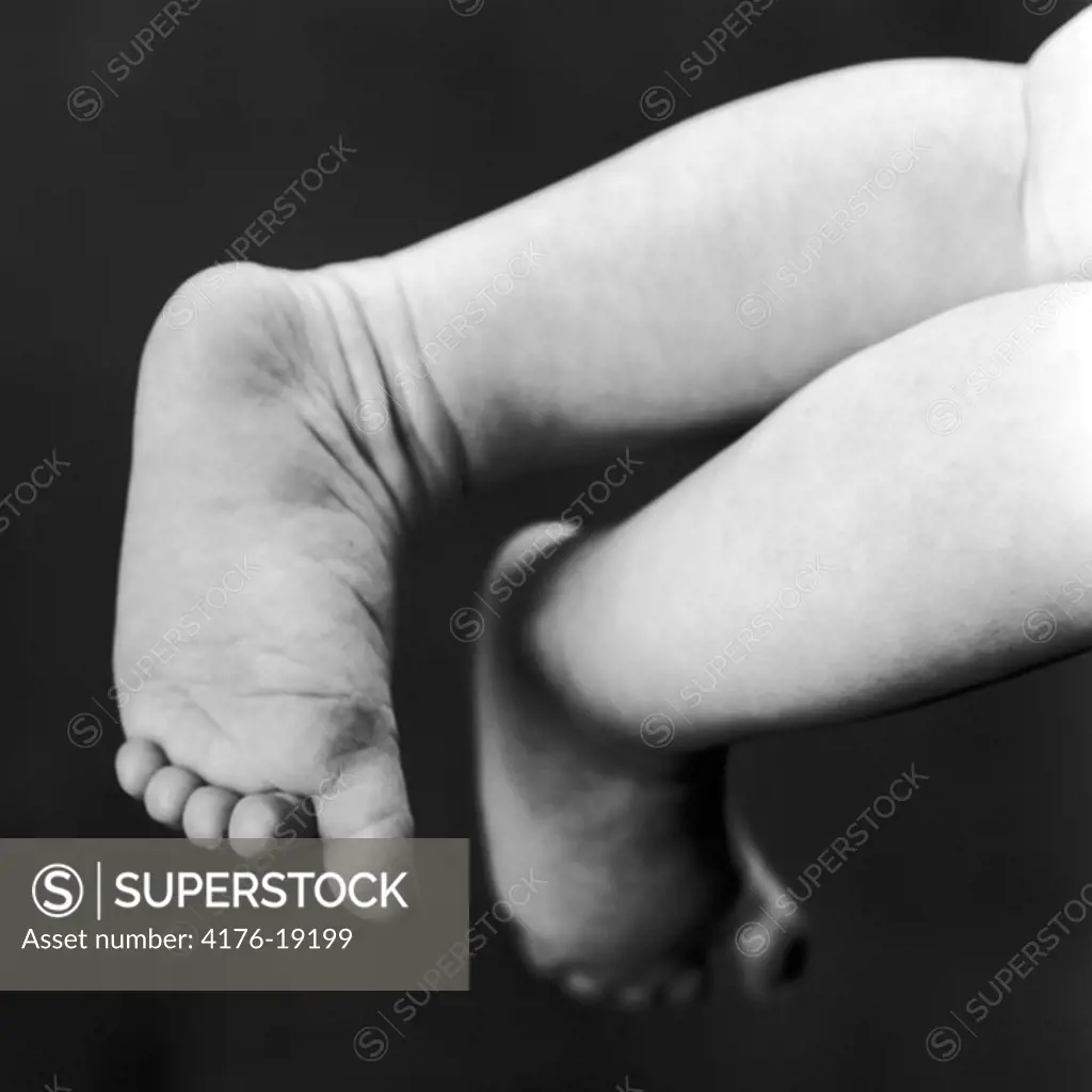 Studio shot of the bare feet of a baby girl