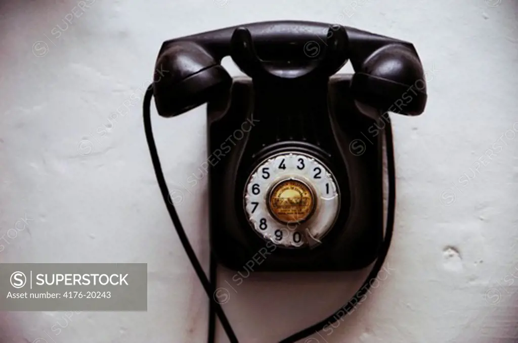 Overhead view of a black rotary telephone in detail