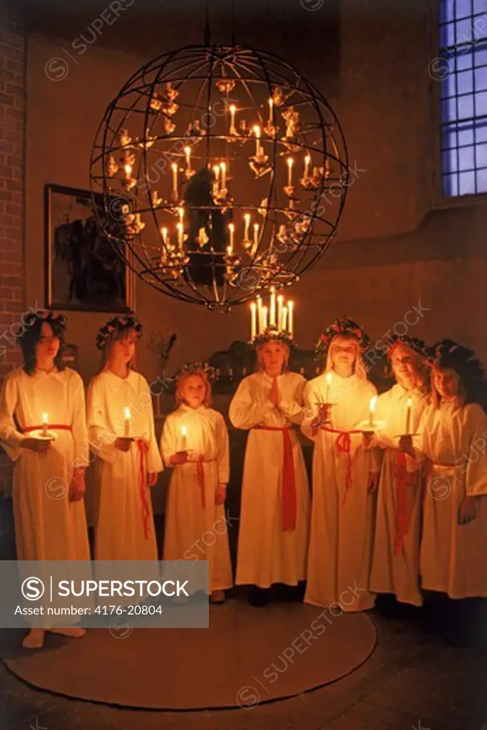 Girls with candles at Kungsholmen Church in Stockholm on Santa Lucia Day December 13
