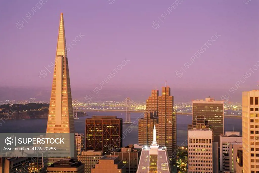 Transamerica Pyramid and Oakland Bay Bridge with San Francisco skyline at dusk