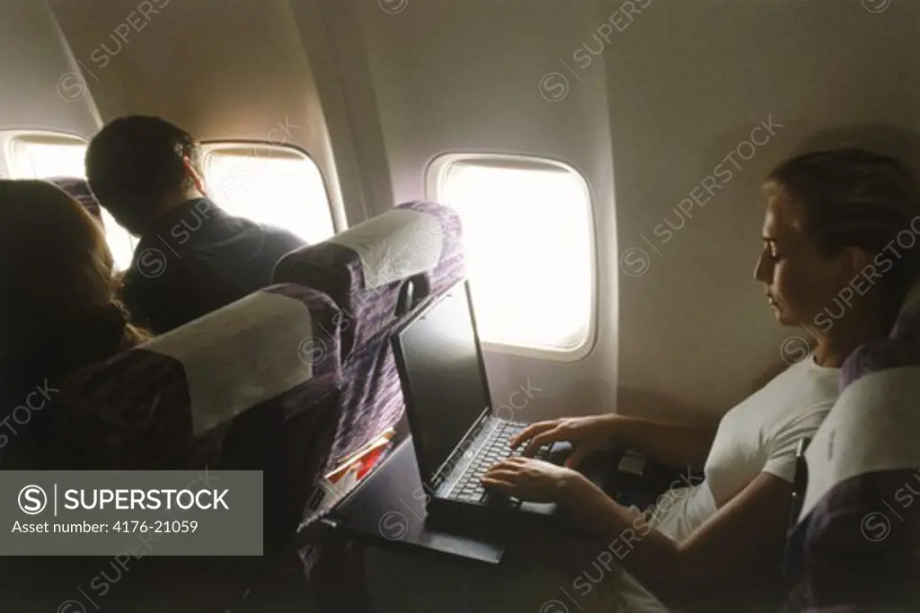 Woman with laptop doing inflight work