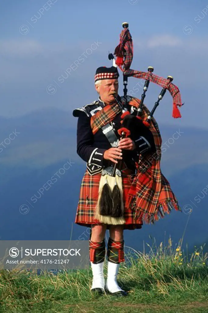 Bagpiper at Loch Broom in Scottish highlands