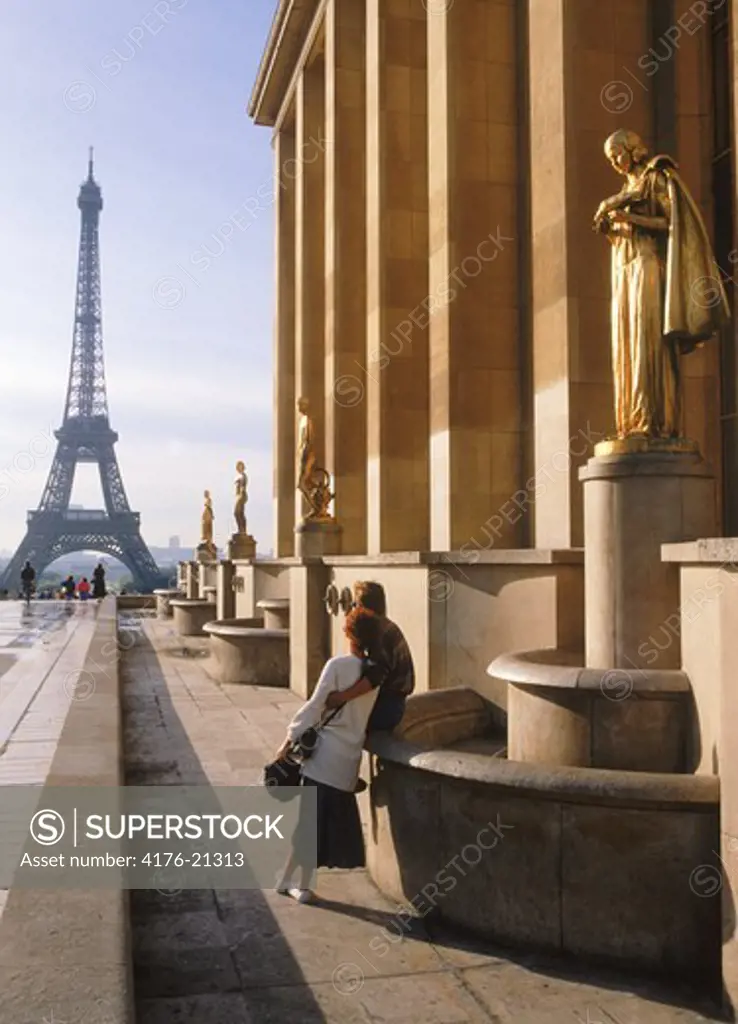 Couple at Palais Chaillot with Golden Figurines and Eiffel Tower at sunrise