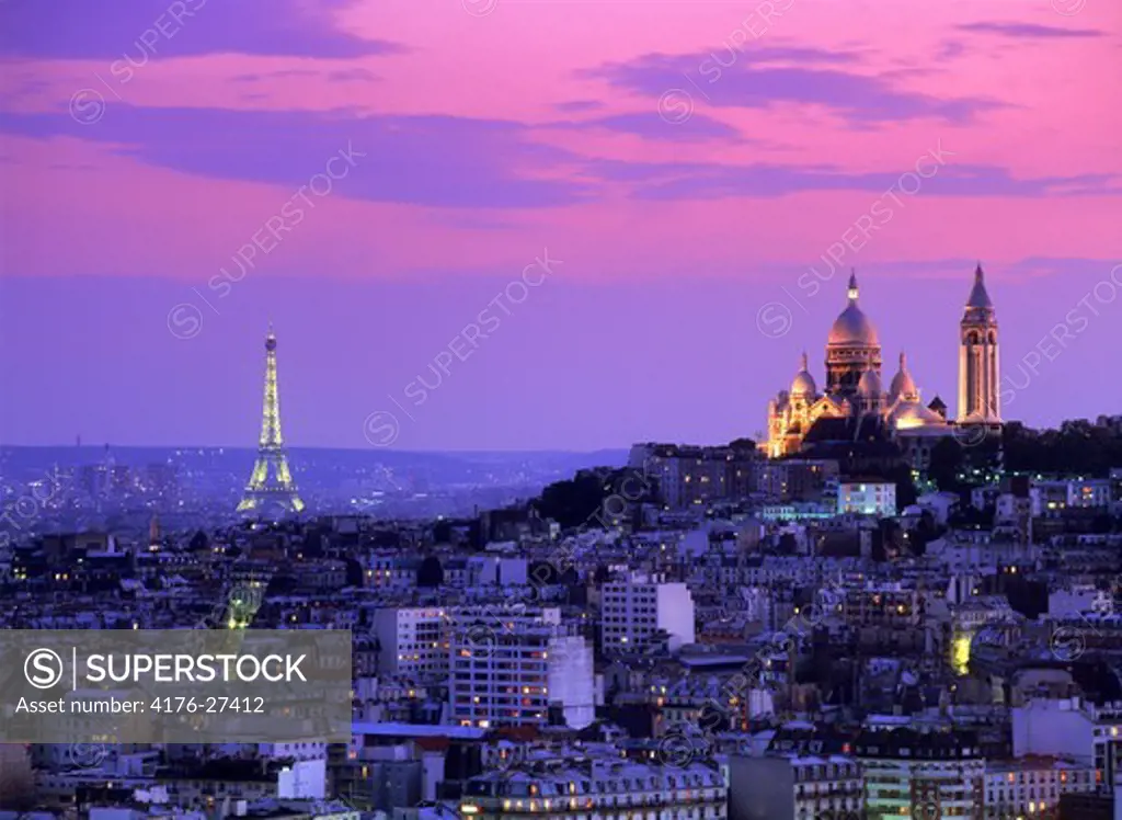 Sacre-Coeur and Eiffel Tower above Paris skyline at dusk