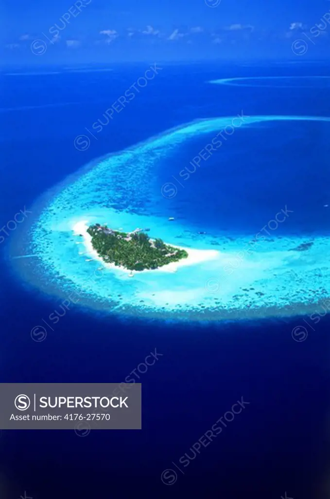 Aerial view of Mayafushi Island with encircling reef in Maldive Islands in North East Ari Atoll  Indian Ocean