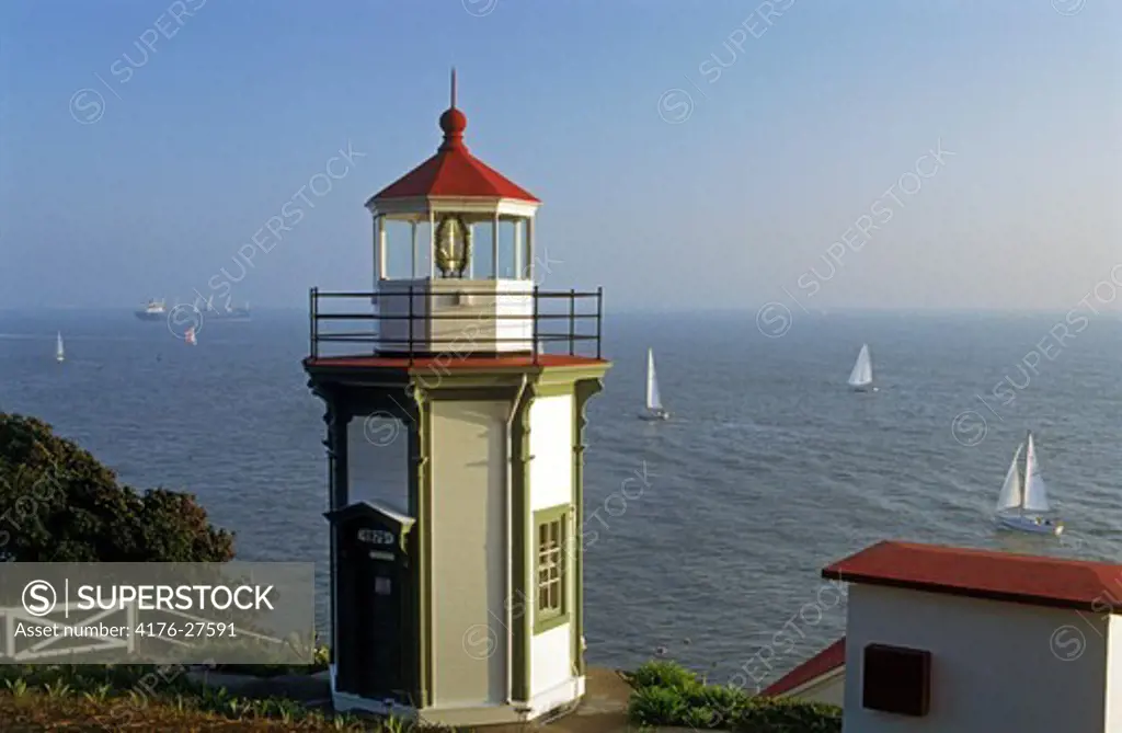 Yerba Buena Lighthouse on Yerba Buena Island with passing sailboats on San Francisco Bay