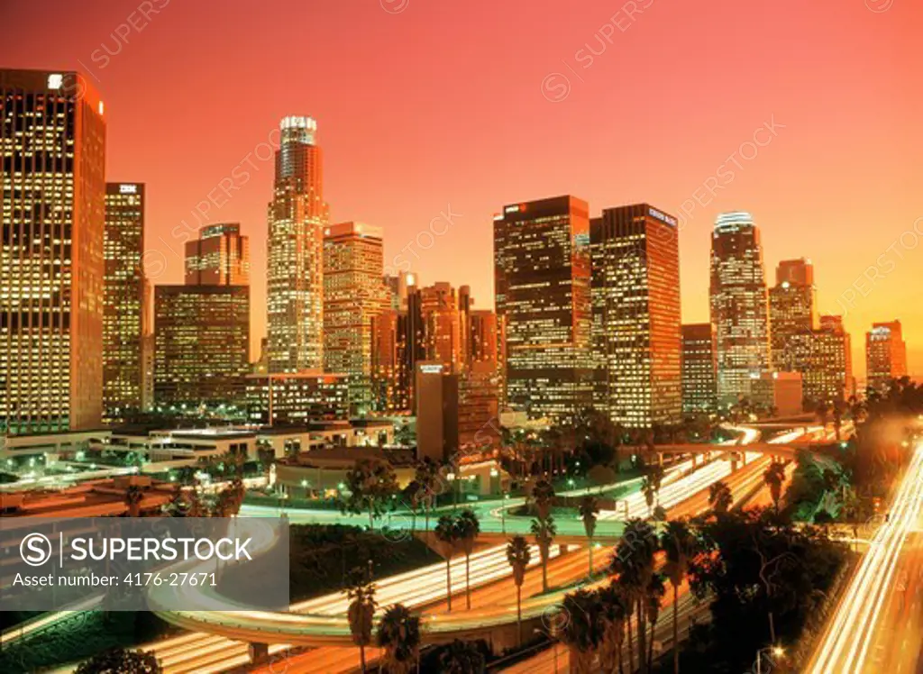 Downtown Los Angeles with passing freeways at dusk