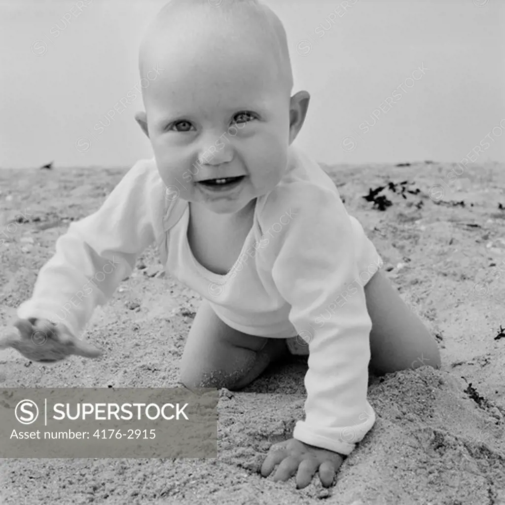 Baby crawling on sand