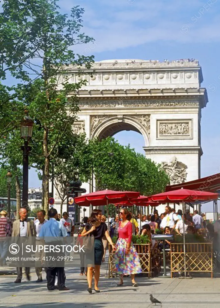 Cafe on Champs Elysees with Arc de Triomphe in Paris