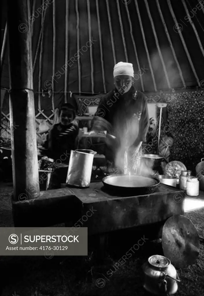 A Mongolian woman cooking, Mongolia