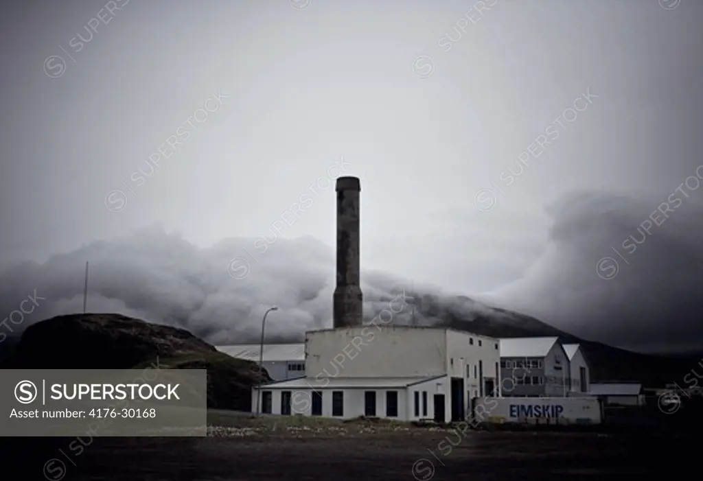 Old factory with menacing clouds above, Iceland