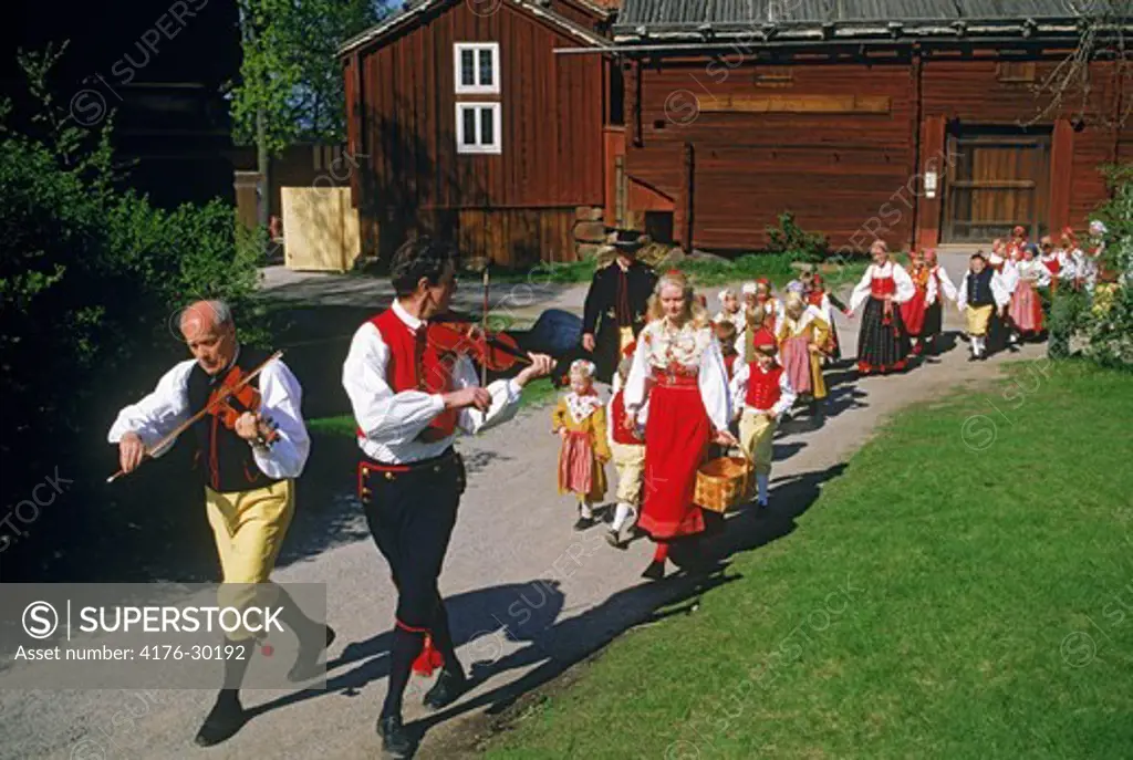 Swedish children and musicians in traditional Midsummer dress at Skansen Park in Stockholm