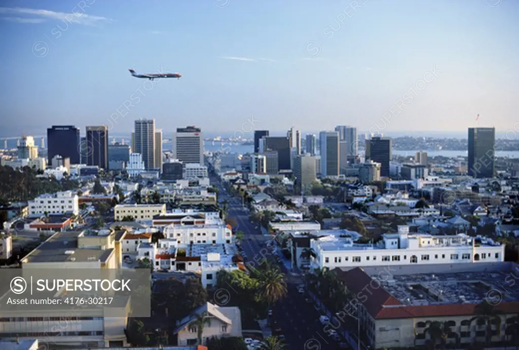 Passenger jet passing over San Diego skyline