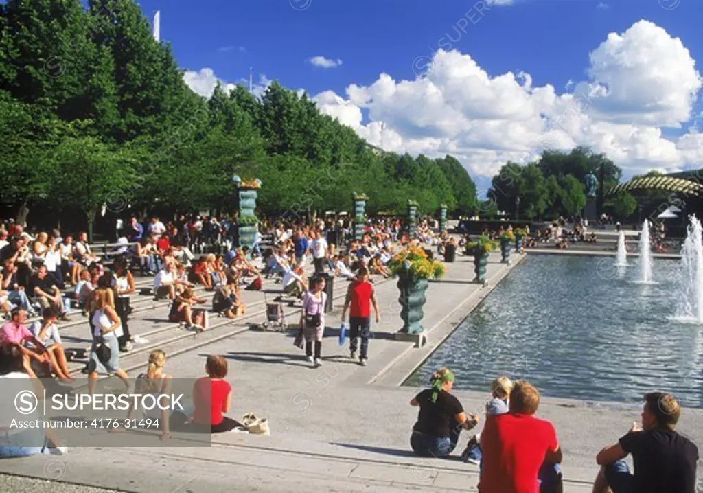 Visitors and fountains at Kungstradgarden in Stockholm in summertime
