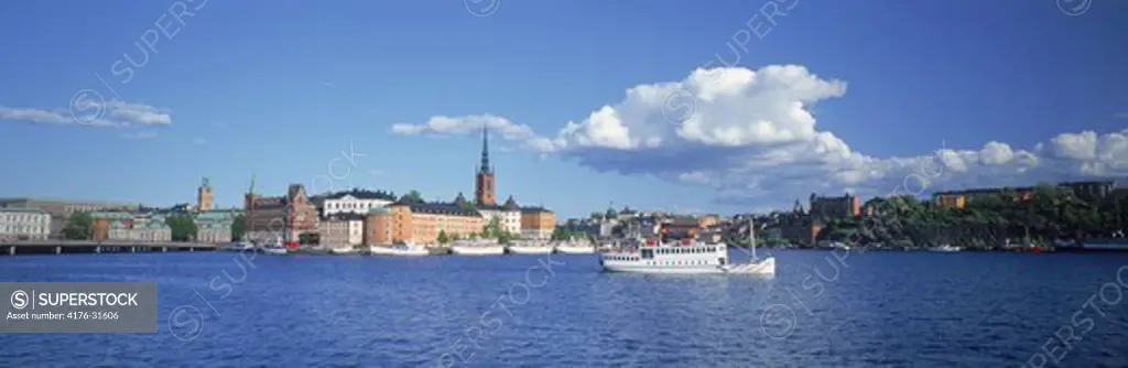 Ferryboat on Riddarfjarden waters with Riddarholmen Island behind in Stockholm
