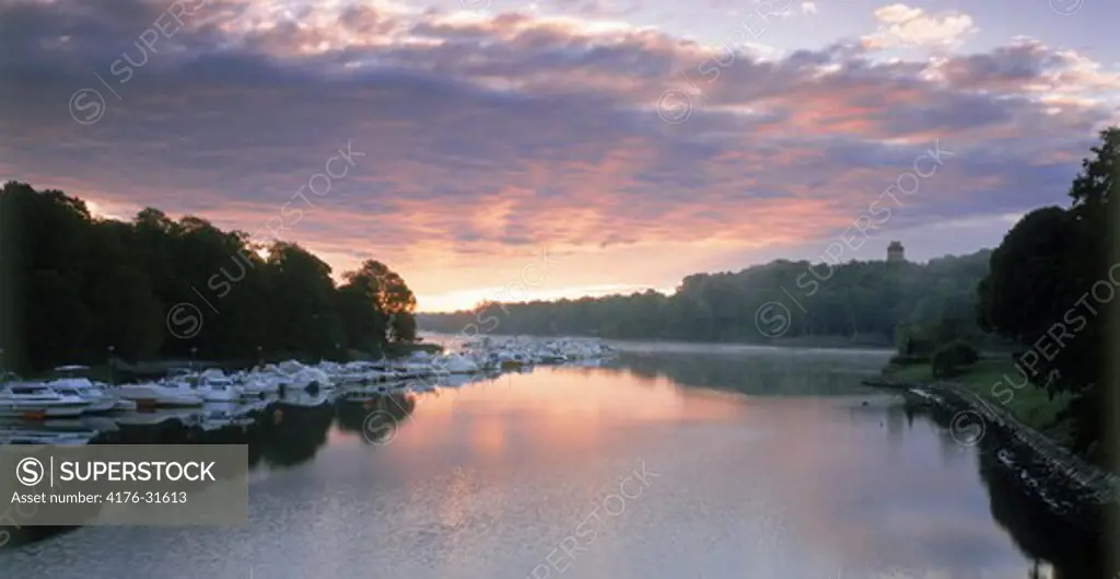 Sunrise over canal with moored boats at Djurgarden in Stockholm