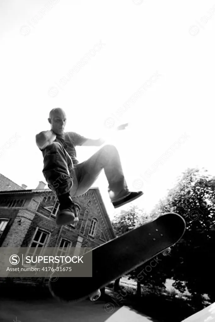Skateboarder Fabian Nilsson doing a 180 frontside kick-flip in a bank. Molndal (Molndal), Sweden.