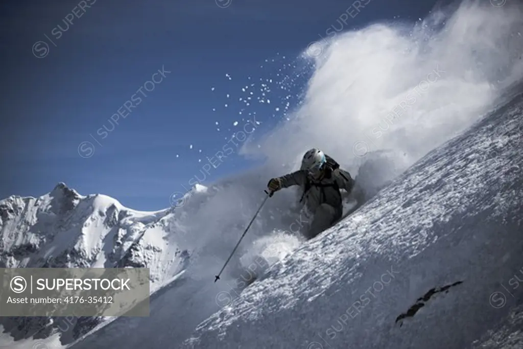 Actionphoto of a skier with a mountain in the background, Alps