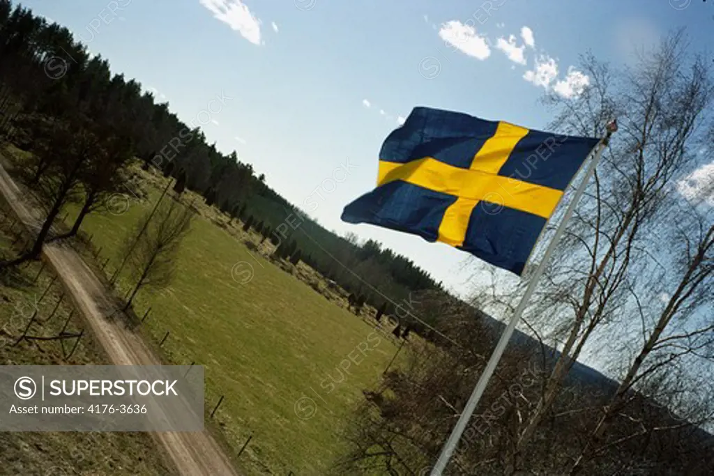 Swedish flag waving on top of a pole. Sweden