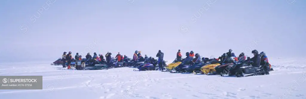 Iceland, Vatnajokull - Group of people snowmobiling
