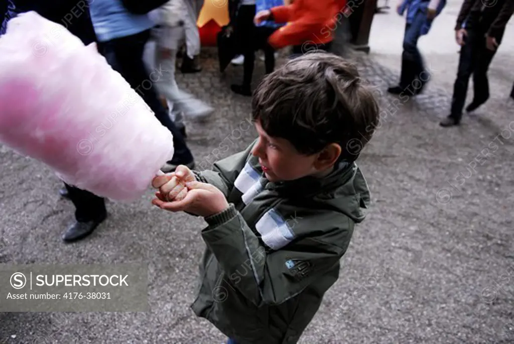 Boy with a candy floss inside Tivoli, Copenhagen, Denmark.