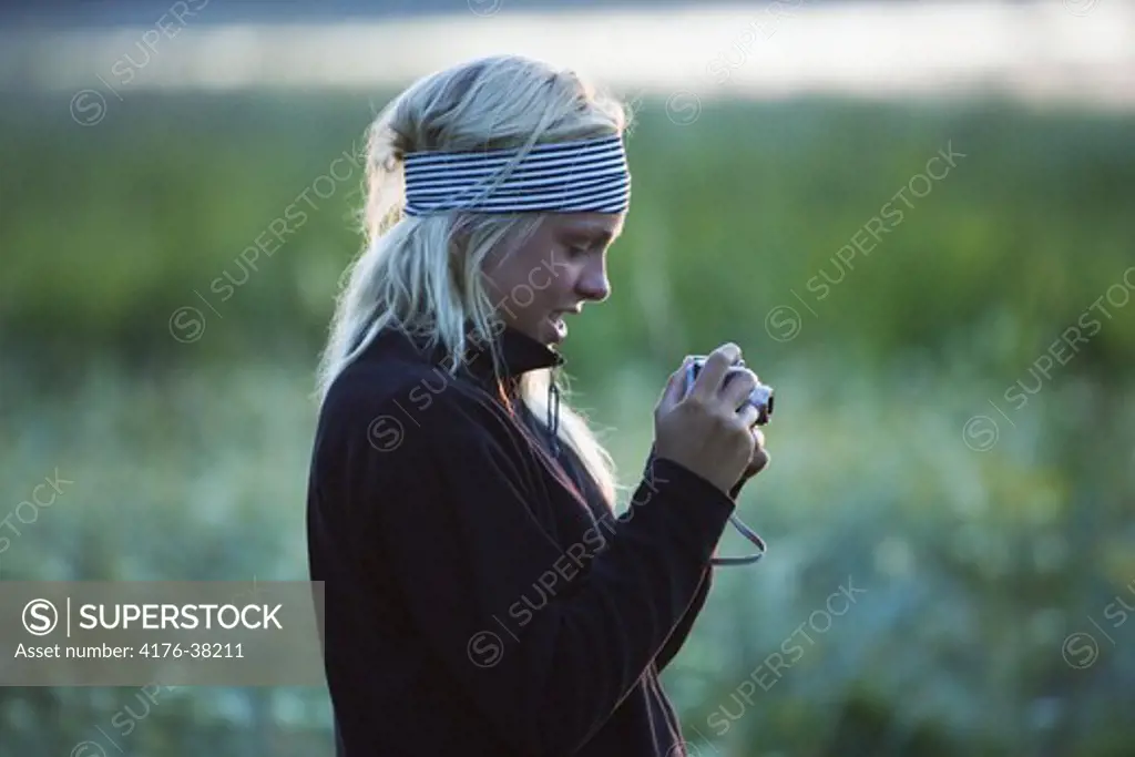 Young girl with digital camera, Sweden
