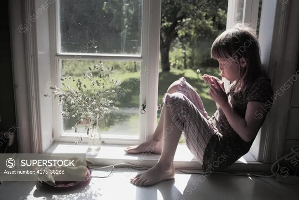 Girl sitting in a window, Sweden