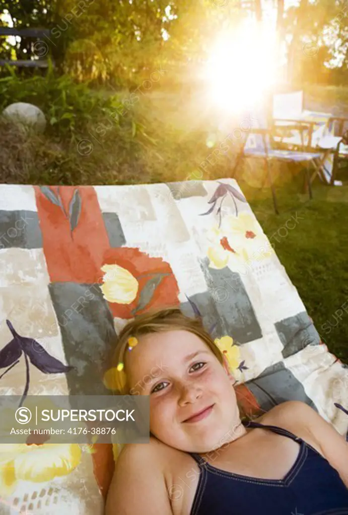 Happy girl in a sun chair