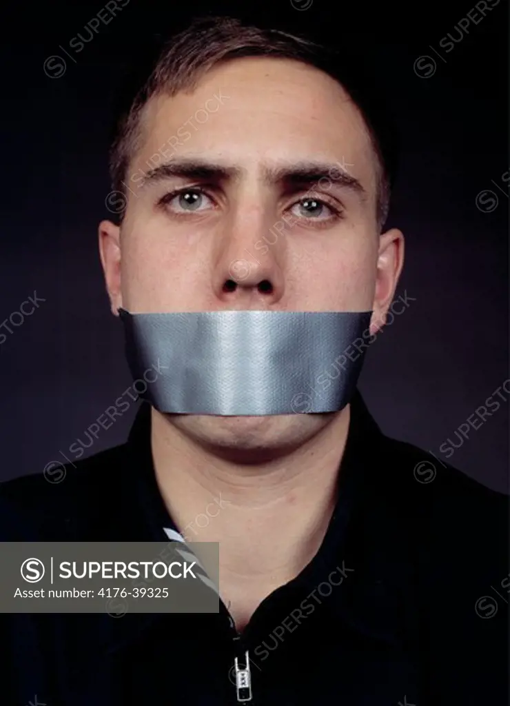 A man posing with silver duct tape across his mouth