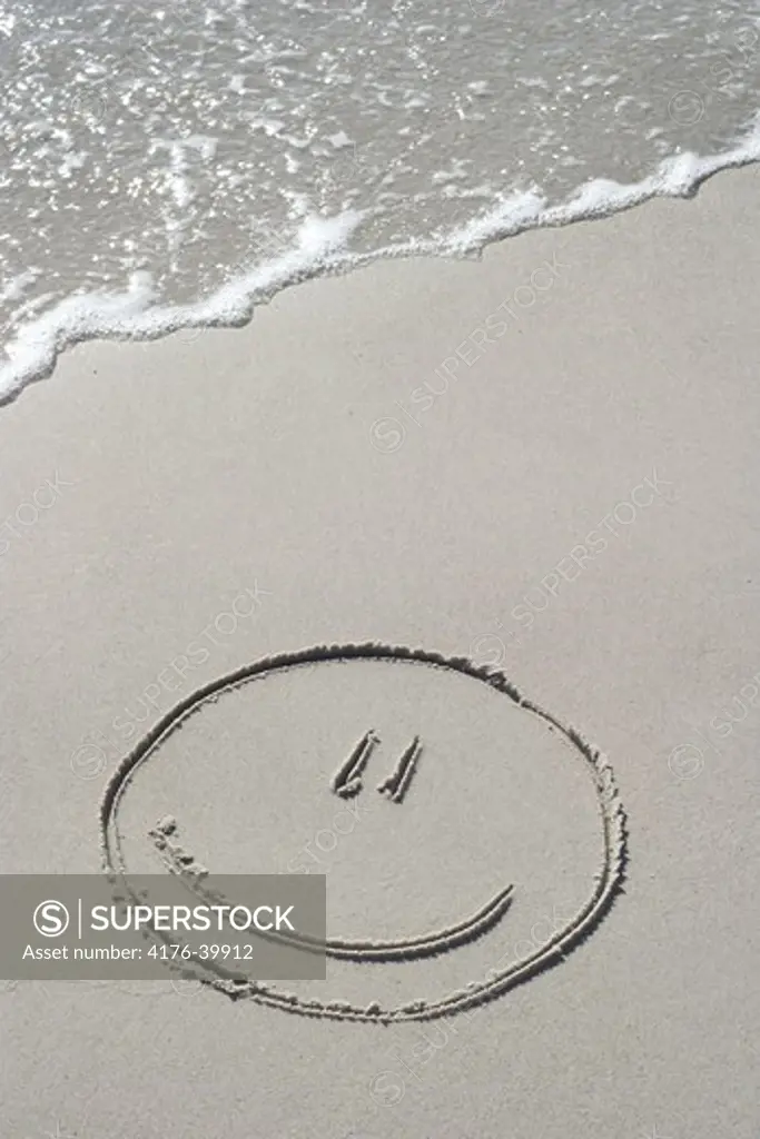A smiley on wet sand