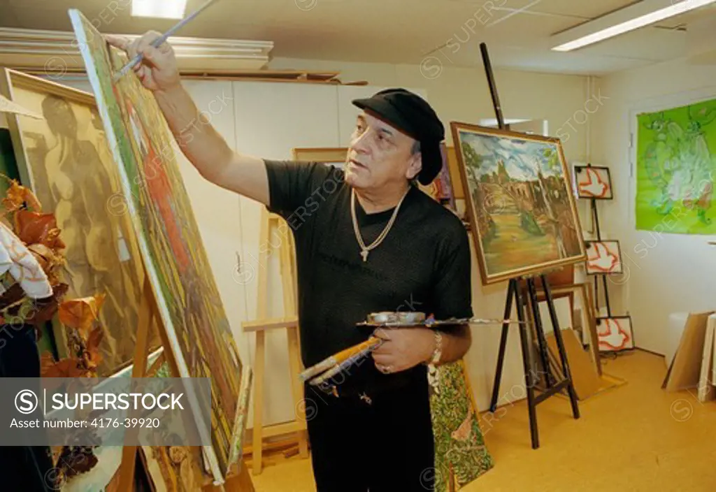 Artist painting in his studio in Rinkeby in Stockholm