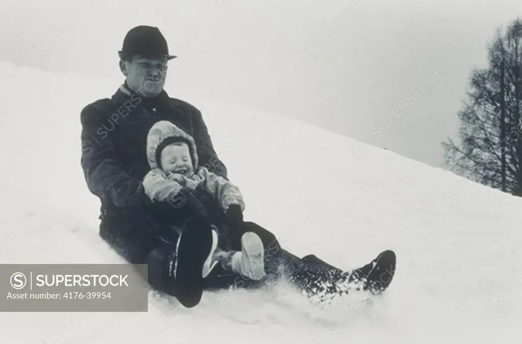 Father and his child on a sled