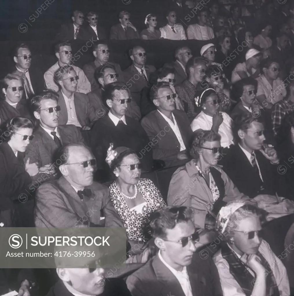 People in a cinema wearing 3D glasses