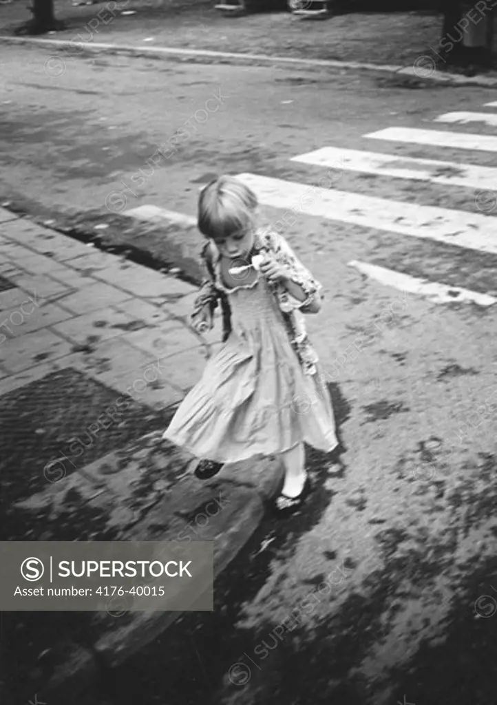 A little girl at a pedestrian crossing