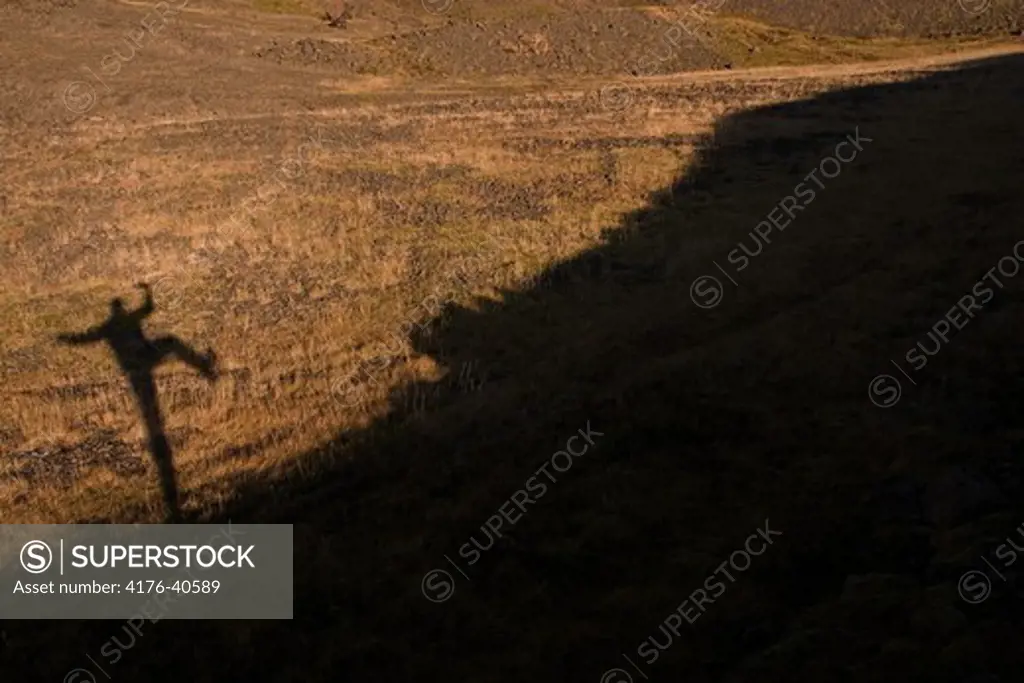 Silhouette of a person about to jump.  Northeast Iceland.