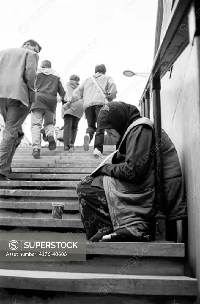 A beggar near Arc de Triumphe in Paris
