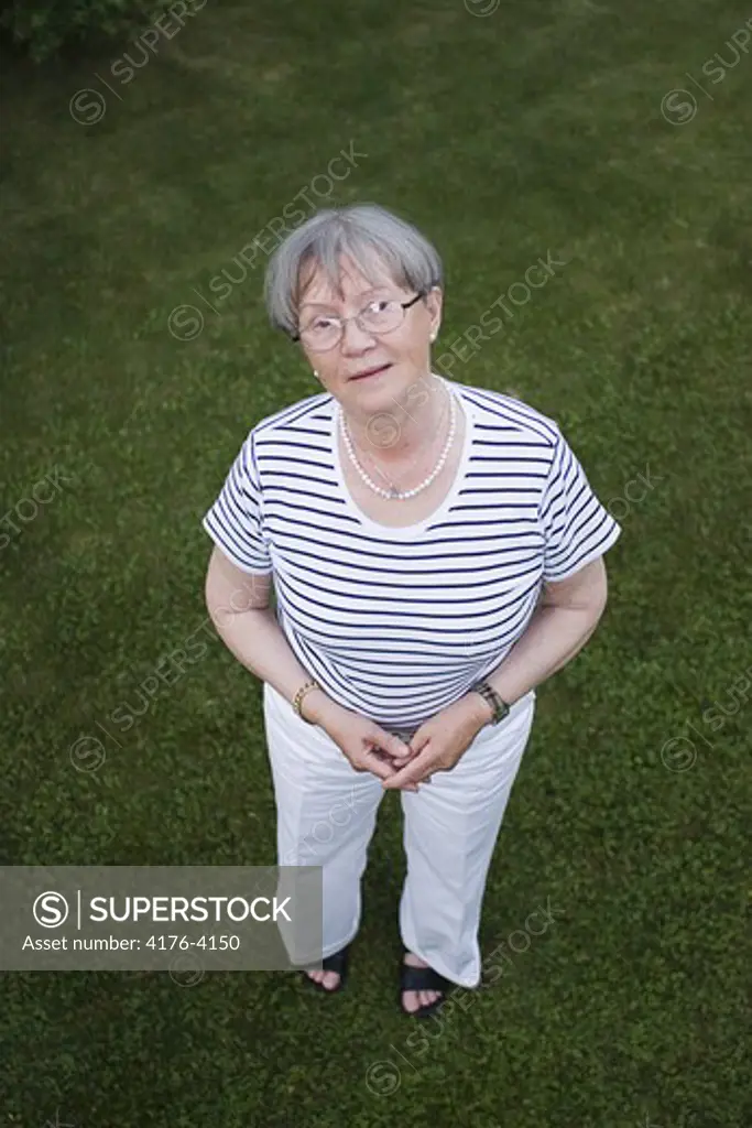 A woman standing on a lawn, Sweden