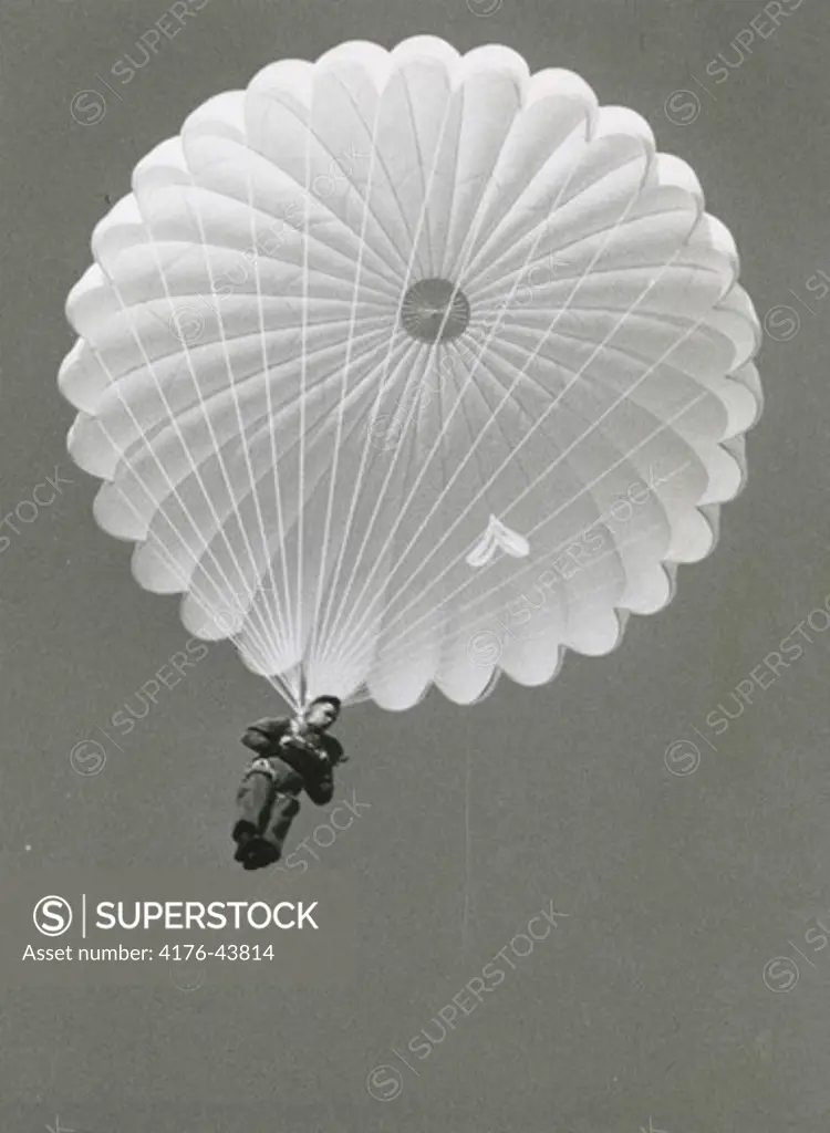 A soldier parachutes from the sky