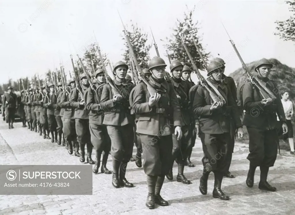 A line of soldiers marching with rifles