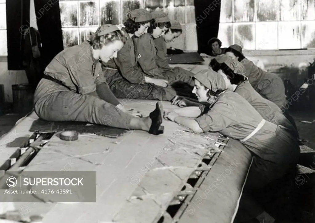 Women working on the wing of a plane