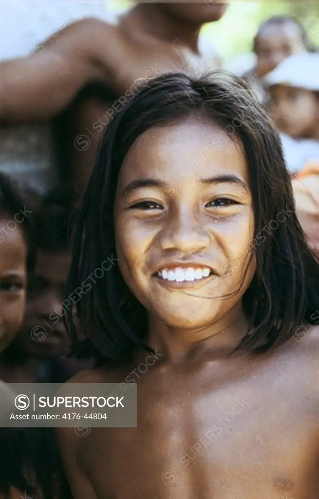 A girl smiling and looking at the camera