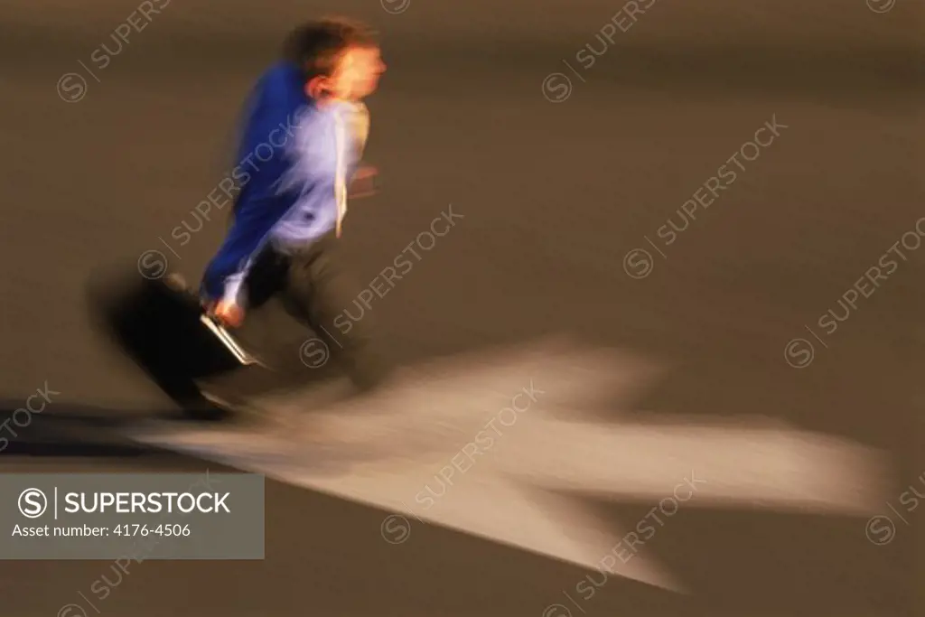 Businessman with briefcase hurrying to work across arrow
