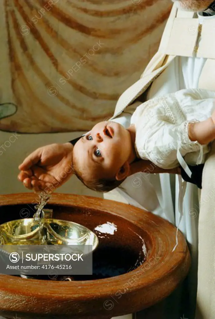 Baby being baptized.