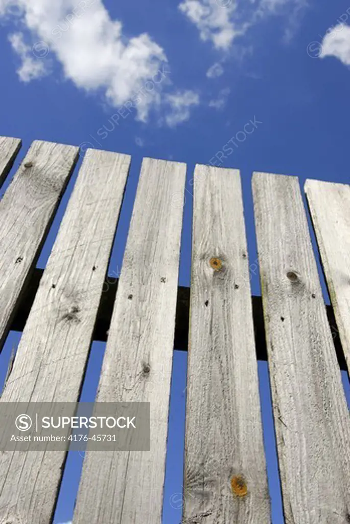 Wooden fence against a blue sky, Copenhagen, Denmark.