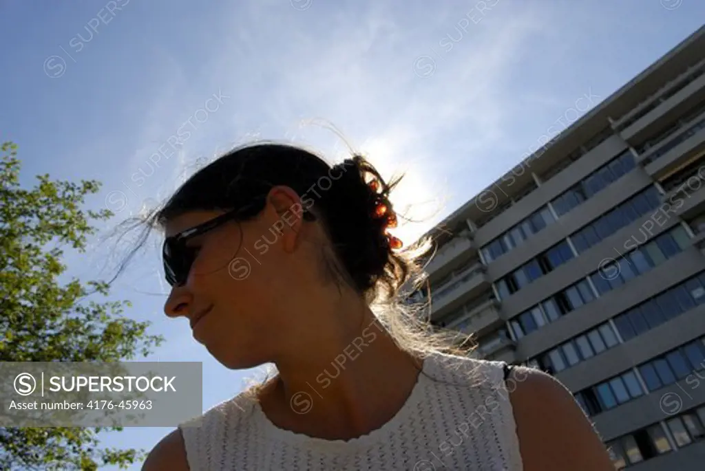 Profile of a woman in front of building, Copenhagen, Denmark.