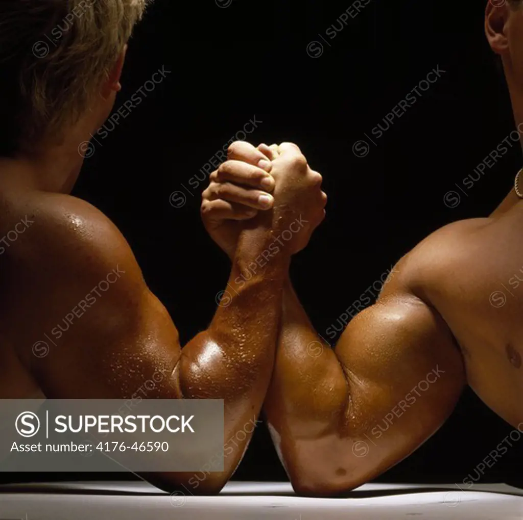 Close-up of two men arm wrestling