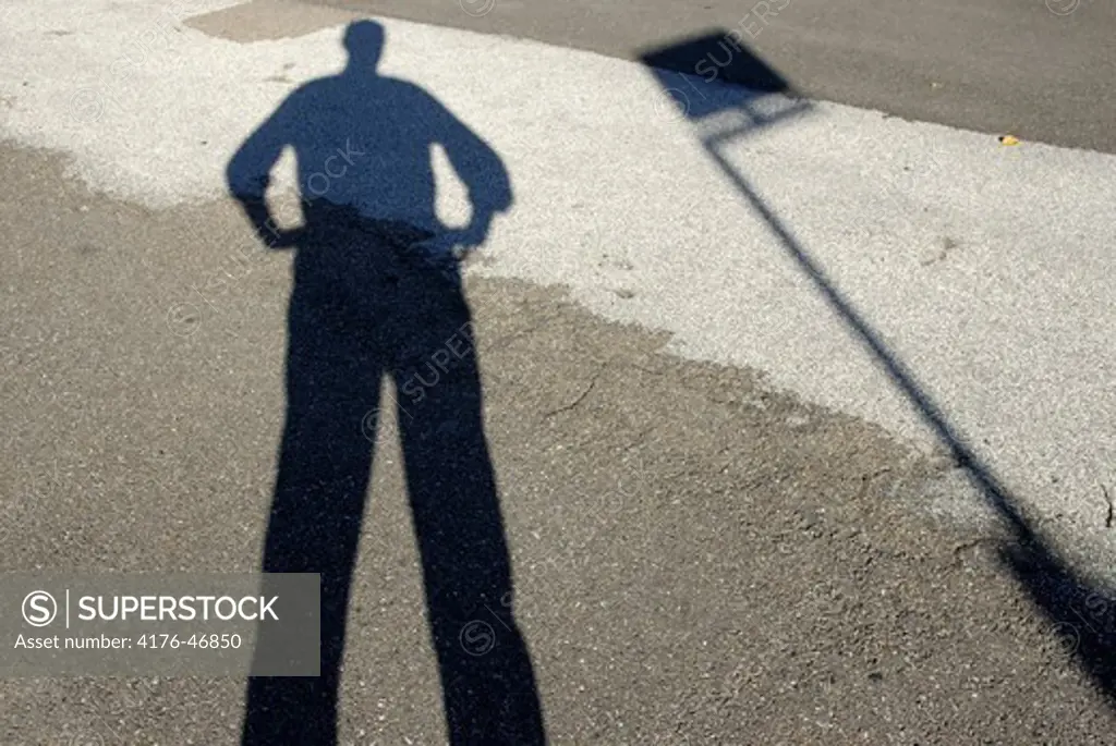 Shadow of man waiting for the city bus in Copenhagen, Denmark.